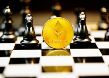 a gold ether coin sitting on top of a chess board