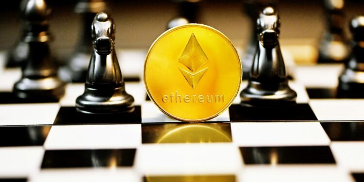 a gold ether coin sitting on top of a chess board